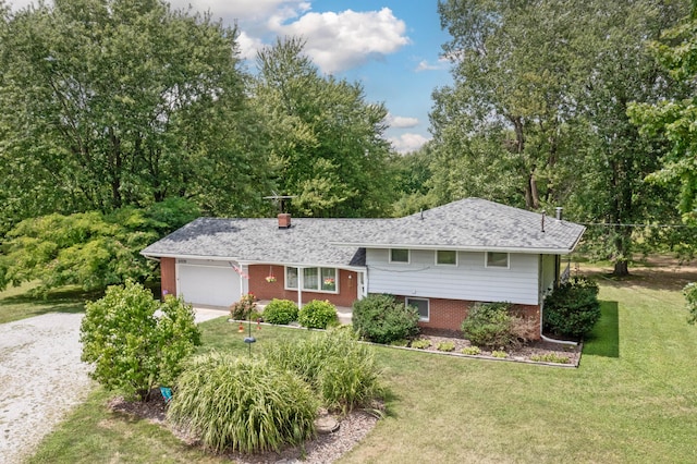 view of front of property with a garage and a front lawn