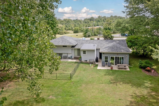 back of house featuring a yard and a patio