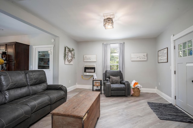 living room with light hardwood / wood-style floors and heating unit