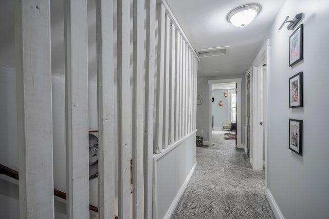 hallway with light colored carpet