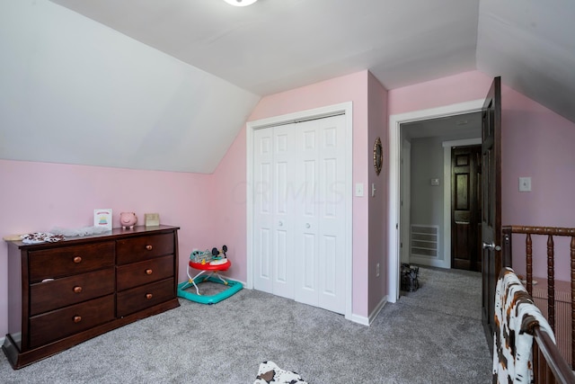 bedroom featuring carpet, a closet, and lofted ceiling