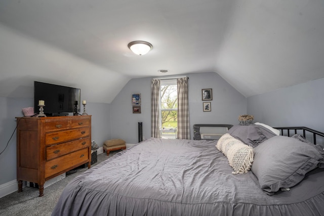 carpeted bedroom with lofted ceiling