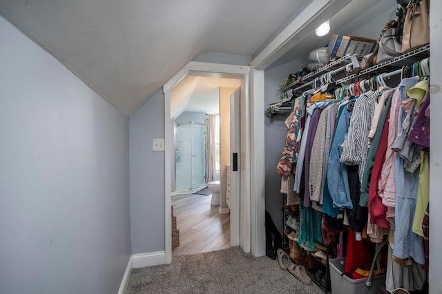 spacious closet featuring hardwood / wood-style floors and lofted ceiling