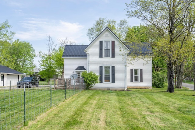 back of house with a lawn