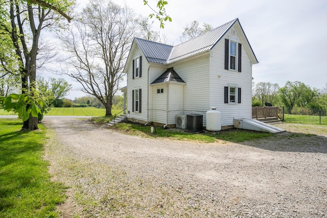 view of side of home featuring central AC