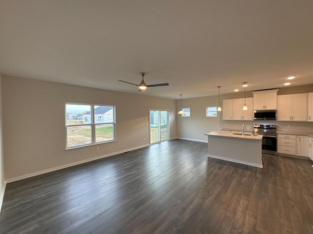 kitchen featuring dark wood-type flooring, white cabinets, ceiling fan, decorative light fixtures, and stainless steel appliances