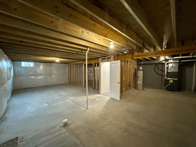 basement featuring heating unit and water heater