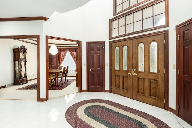 tiled entryway featuring a high ceiling