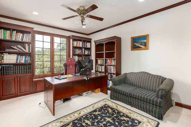 carpeted home office with ceiling fan and crown molding