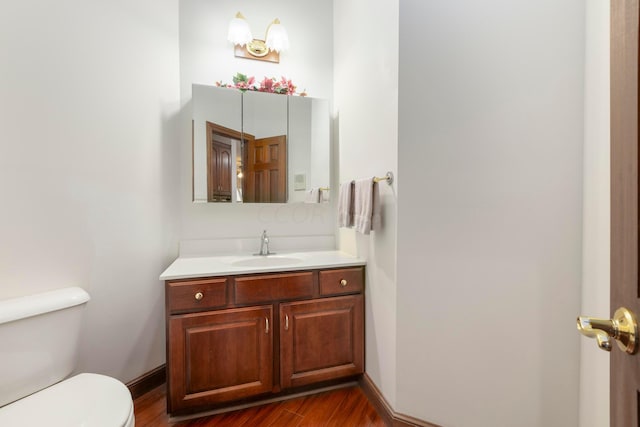 bathroom featuring hardwood / wood-style floors, vanity, and toilet