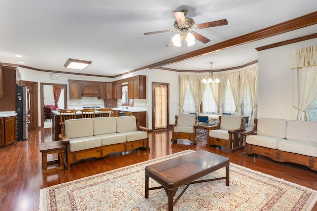 living room with a textured ceiling, crown molding, ceiling fan with notable chandelier, and hardwood / wood-style flooring