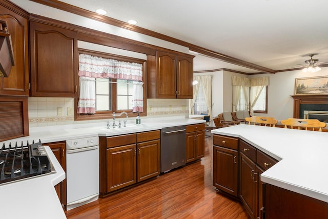 kitchen with dishwasher, dark wood-type flooring, a healthy amount of sunlight, and sink