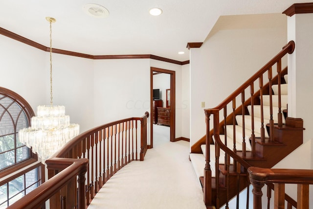 corridor with a chandelier, light carpet, and crown molding