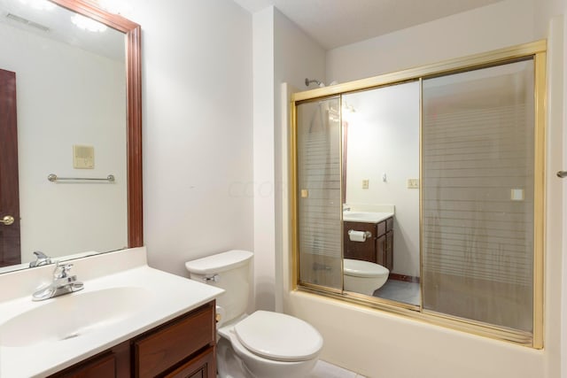 full bathroom with vanity, enclosed tub / shower combo, and toilet