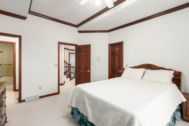 bedroom with ceiling fan, crown molding, ensuite bathroom, and light carpet