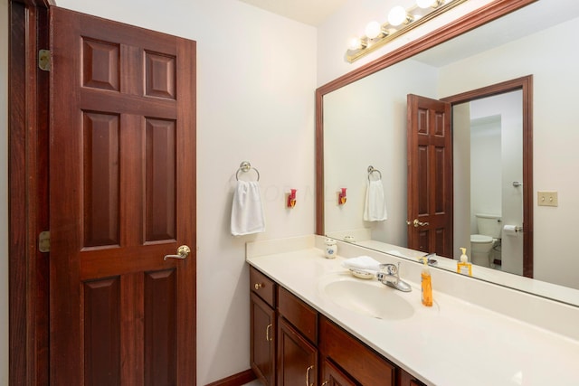 bathroom featuring vanity and toilet