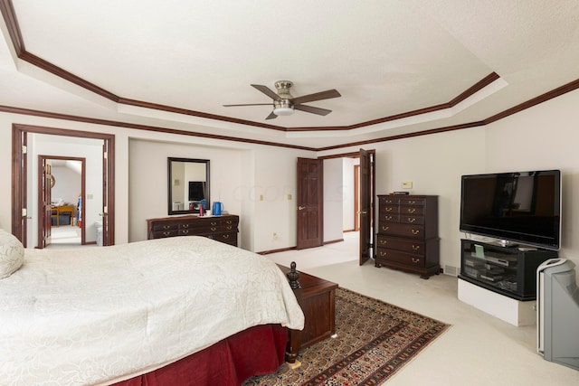 bedroom with a tray ceiling, ceiling fan, and ornamental molding