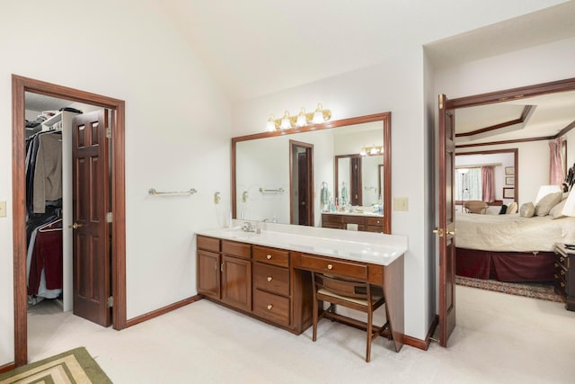 bathroom featuring vanity and lofted ceiling