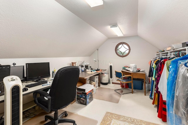 office with a textured ceiling, light carpet, and lofted ceiling