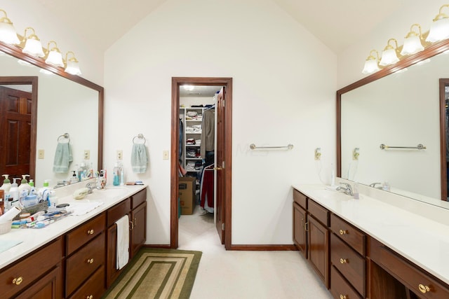 bathroom featuring vanity and lofted ceiling