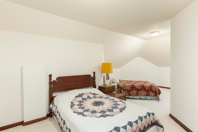 carpeted bedroom featuring lofted ceiling