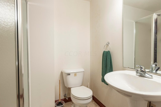 bathroom featuring walk in shower, sink, tile patterned flooring, and toilet