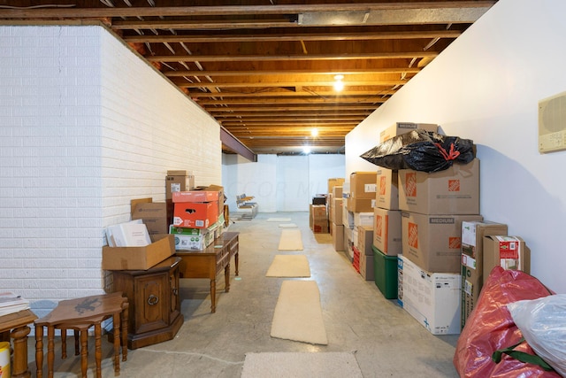 basement featuring brick wall