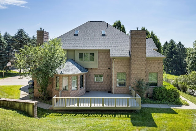 rear view of house with a lawn and a wooden deck