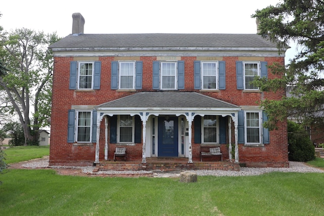 view of front of home with covered porch and a front yard