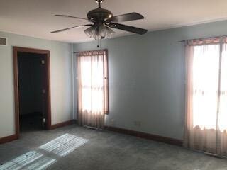 unfurnished room featuring plenty of natural light and ceiling fan