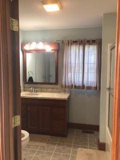 bathroom featuring vanity and toilet