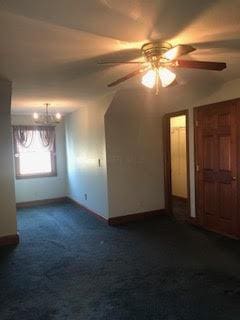 empty room with carpet floors and ceiling fan