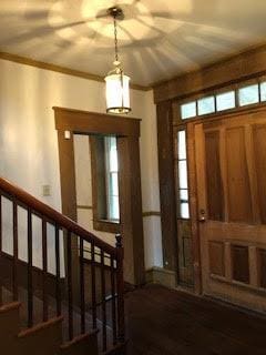 foyer entrance featuring crown molding