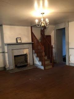 unfurnished living room with a notable chandelier