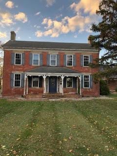 view of front of home featuring a yard and a porch