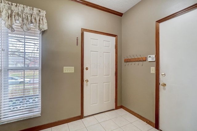 tiled foyer featuring plenty of natural light and a textured ceiling