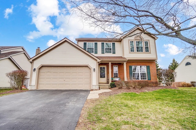 view of property with a garage and a front lawn