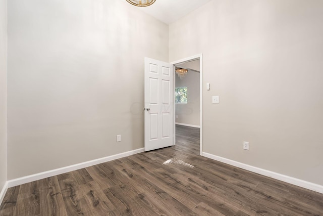 empty room with dark hardwood / wood-style flooring