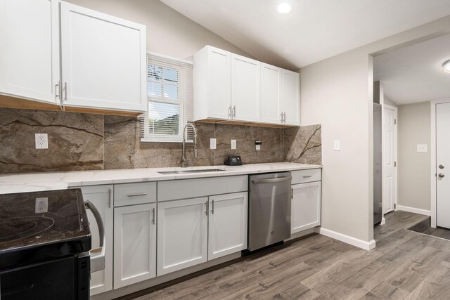 kitchen featuring dishwasher, sink, vaulted ceiling, black range, and white cabinets