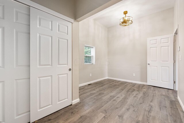 interior space featuring light hardwood / wood-style floors and a notable chandelier