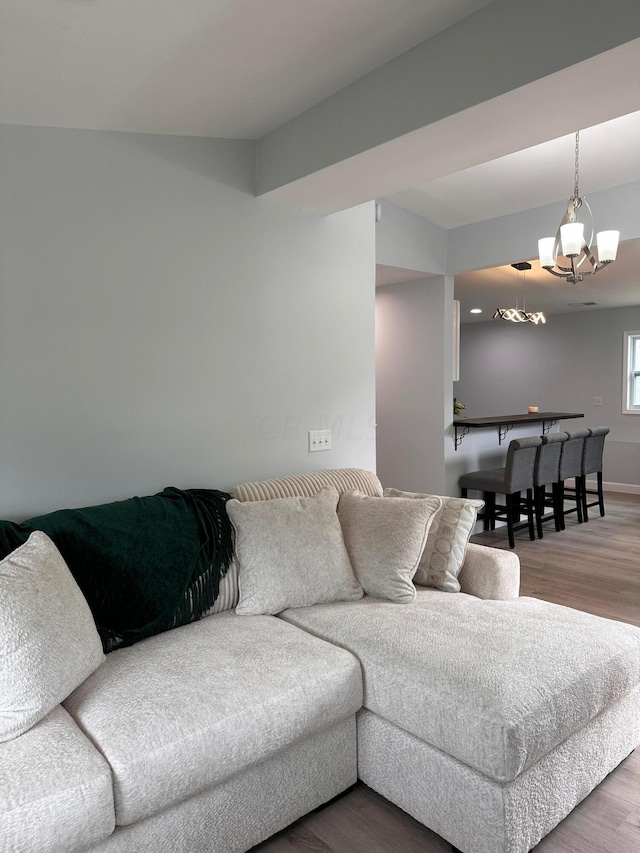 living room featuring a chandelier and hardwood / wood-style flooring