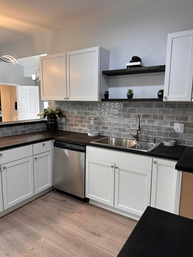 kitchen featuring dishwasher, sink, tasteful backsplash, light hardwood / wood-style floors, and white cabinets