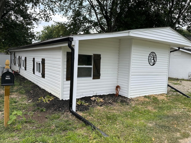 view of side of home featuring a lawn