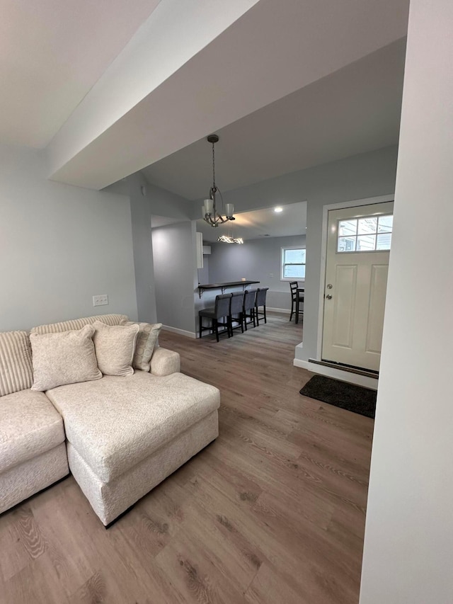 living room with wood-type flooring and an inviting chandelier