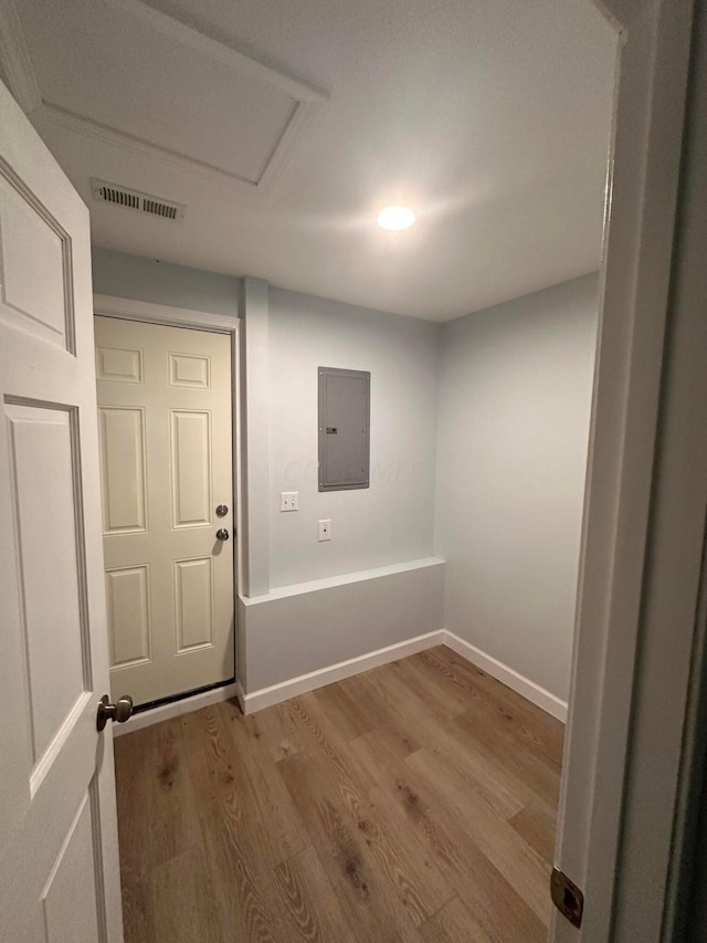 interior space with electric panel and light hardwood / wood-style floors