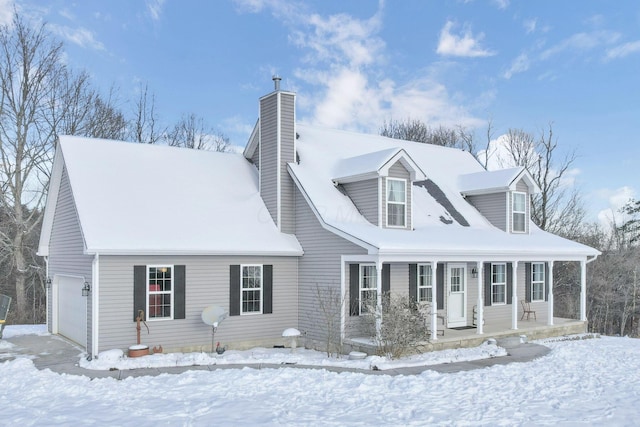 new england style home featuring covered porch and a garage