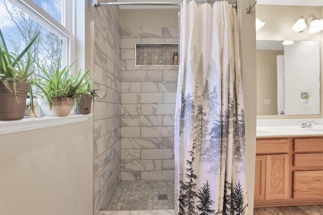 bathroom with curtained shower and vanity