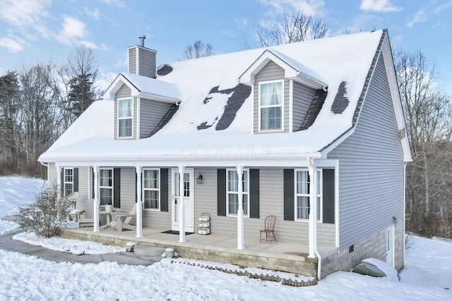 cape cod-style house with covered porch