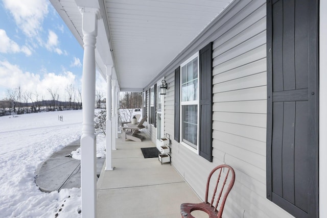 snow covered patio with covered porch