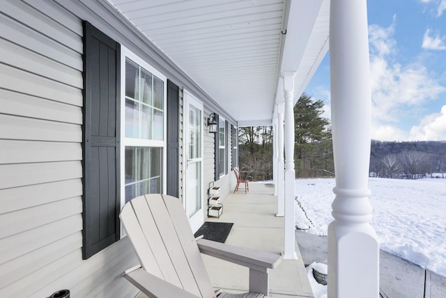 snow covered patio with covered porch